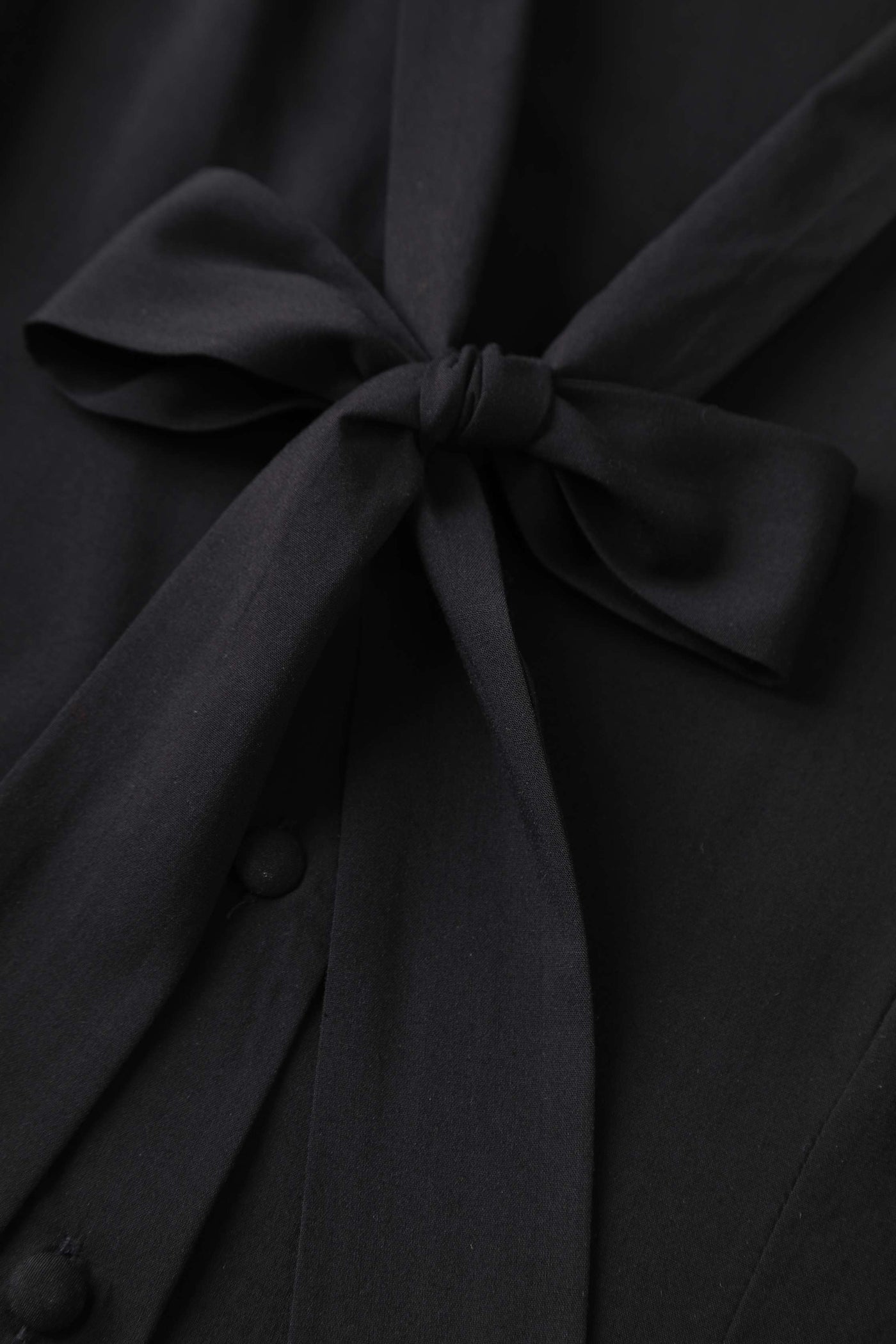 A bow tie of Margaret Long Sleeved Blouse In Black