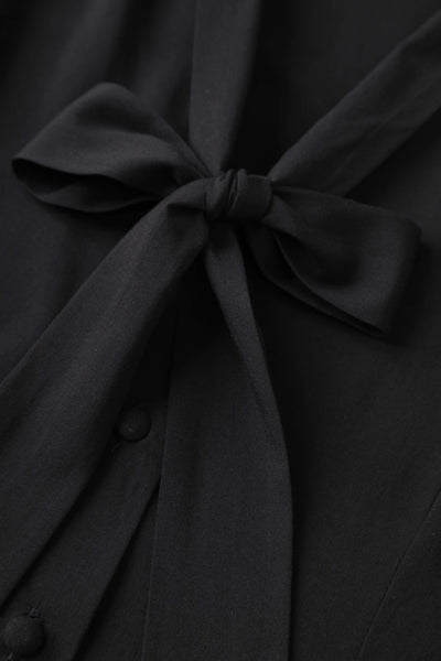 A bow tie of Margaret Long Sleeved Blouse In Black