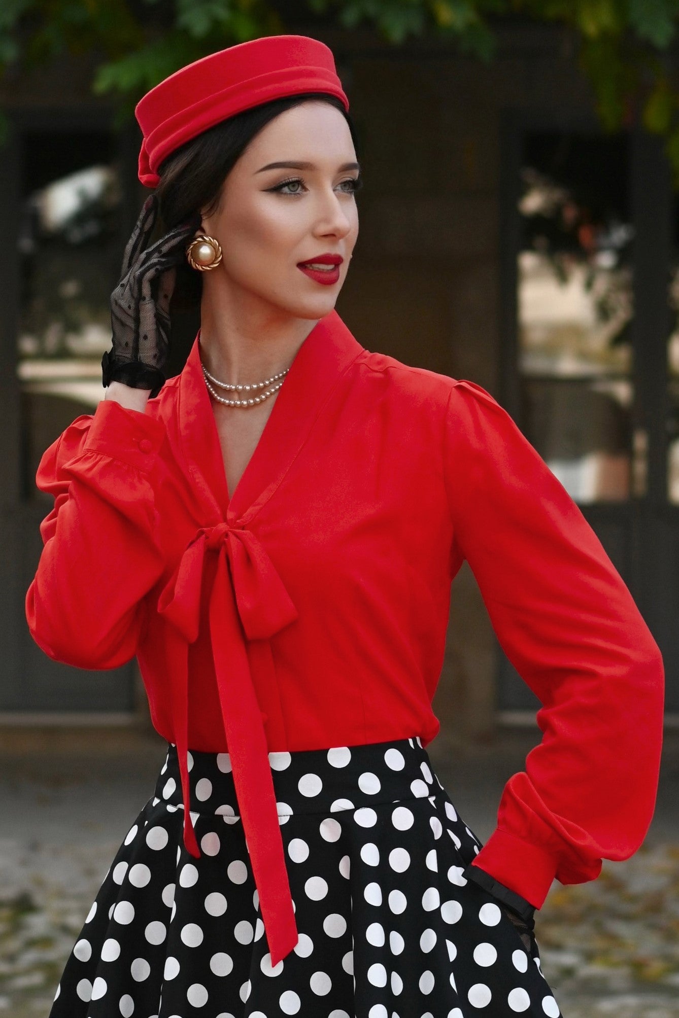 A model wearing a Margaret Long Sleeved Blouse In Red