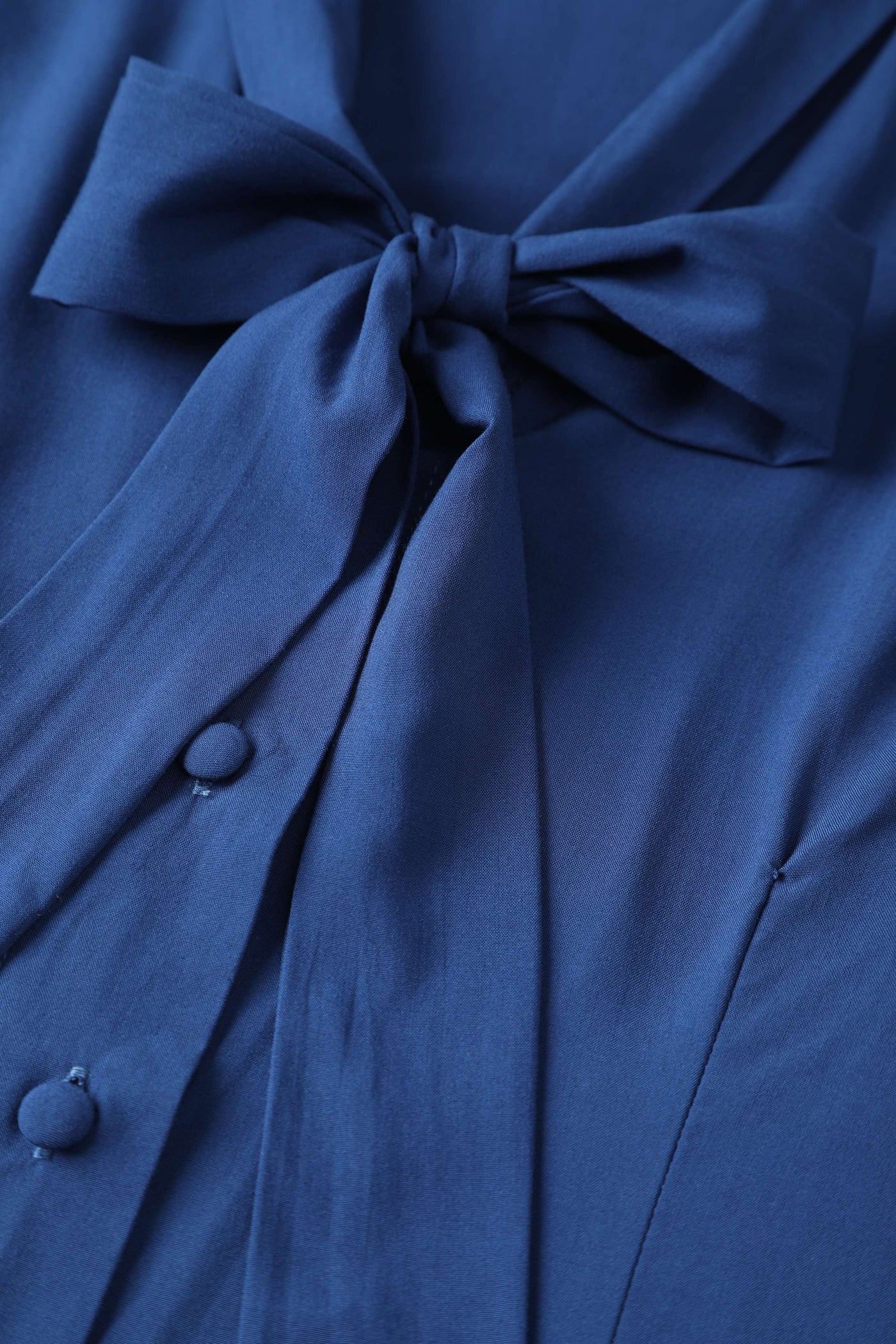 A bow tie collar of Margaret Long Sleeved Blouse In Royal Blue