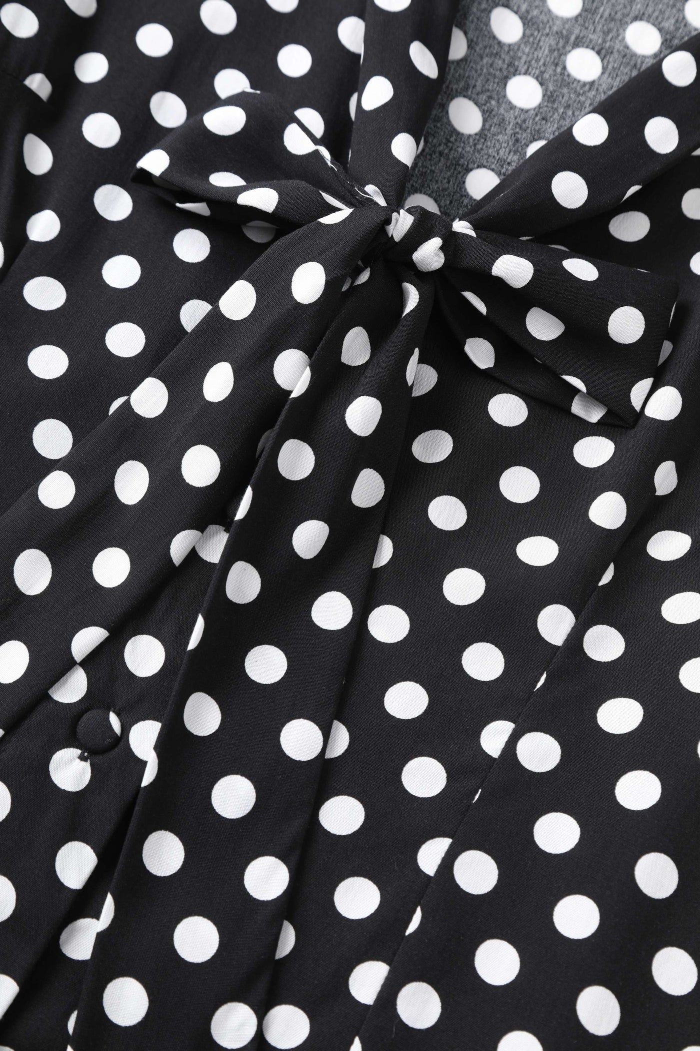A bow tie of Margaret Polka Dot Long Sleeved Blouse In Black
