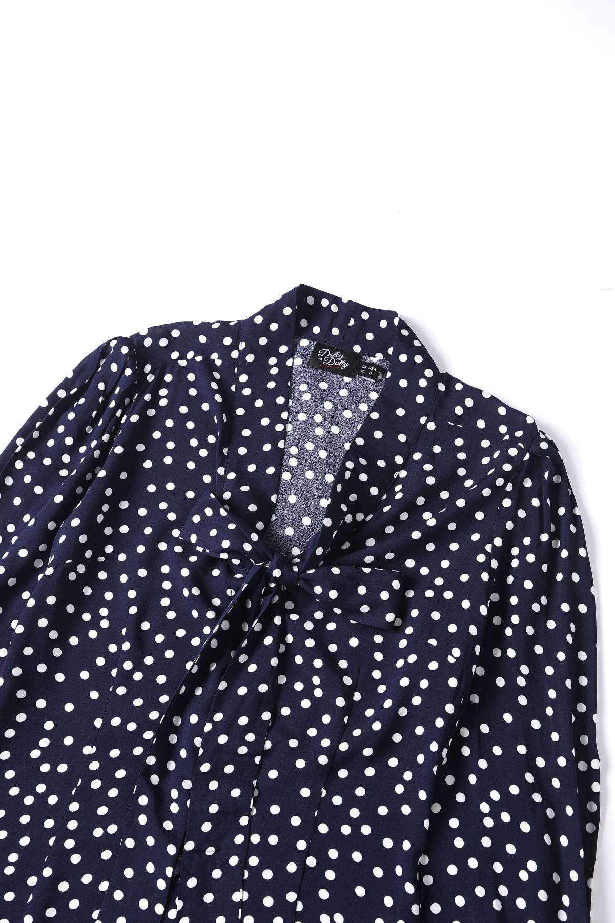 Close up view the top of Margaret Polka Dot Long Sleeved Blouse In Dark Blue