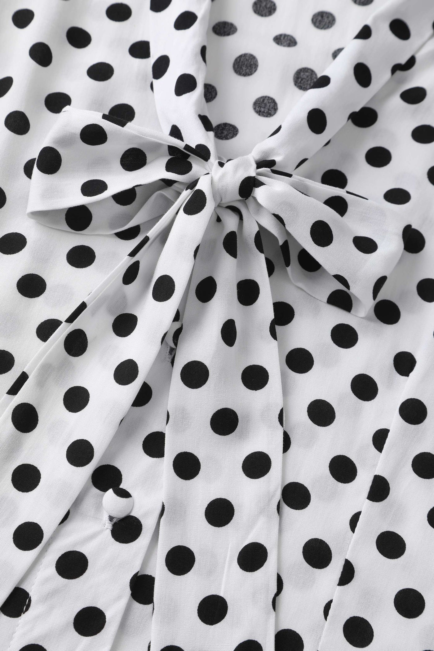 A bow tie collar of Margaret Polka Dot Long Sleeved Blouse In White