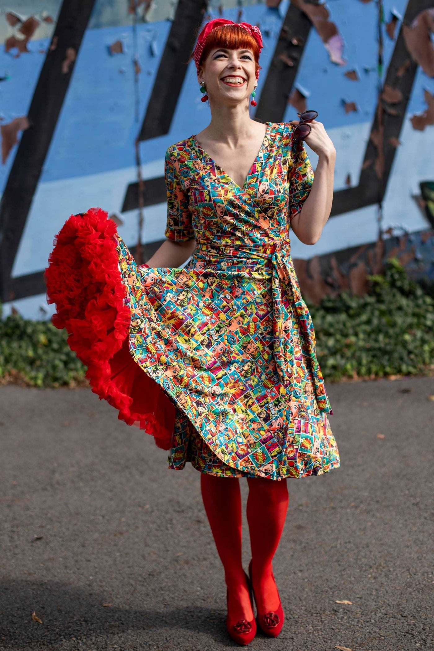 A beautiful model wearing a Matilda Comic Wrap Dress