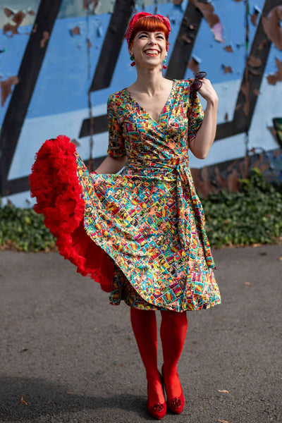 A beautiful model wearing a Matilda Comic Wrap Dress
