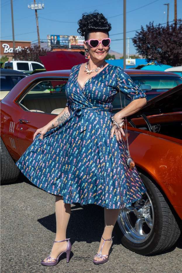 A lady wearing a Matilda Navy Blue Seahorse Wrap Dress