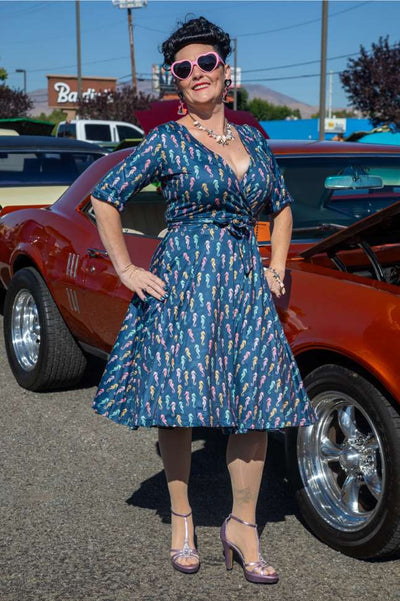 A model wearing a Matilda Navy Blue Seahorse Wrap Dress