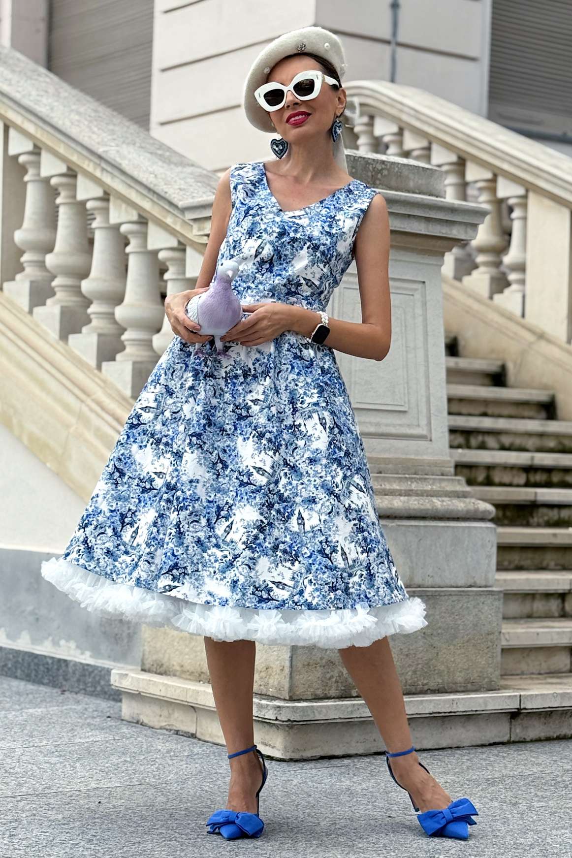 A model wearing a May White Crossover Bust Dress In Big Ben Print