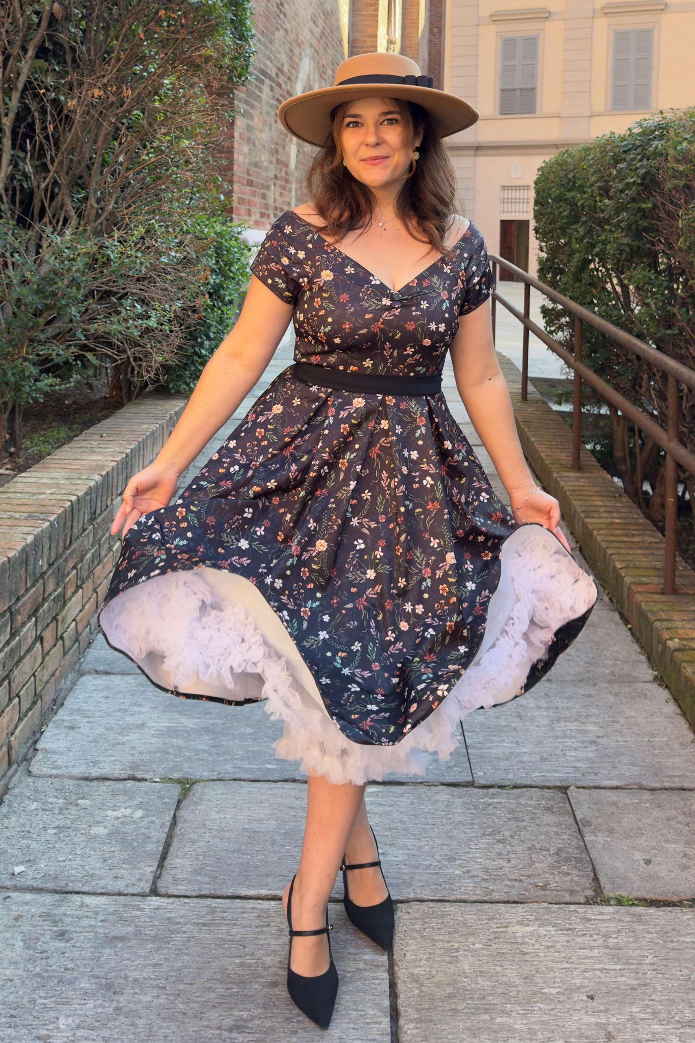 A lovely lady wearing a Meadow Floral Black Off Shoulder Dress