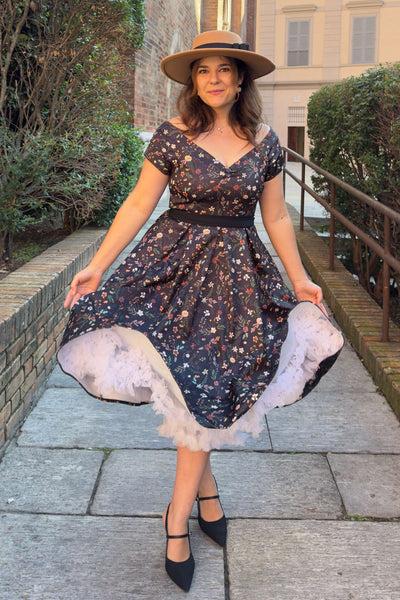A lovely lady wearing a Meadow Floral Black Off Shoulder Dress