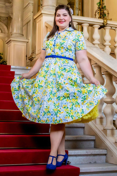 A lady wearing a Mediterranean Lemon Midi Shirt Dress In White