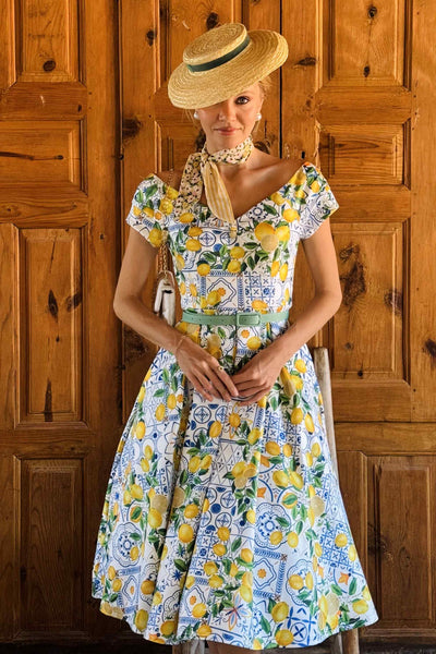 A lady wearing a Mediterranean Lemon Off Shoulder Dress