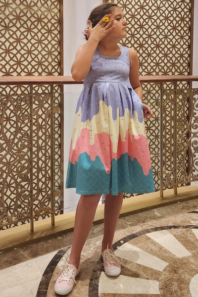 A pretty girl wearing a Kids Melted Ice Cream Swing Dress