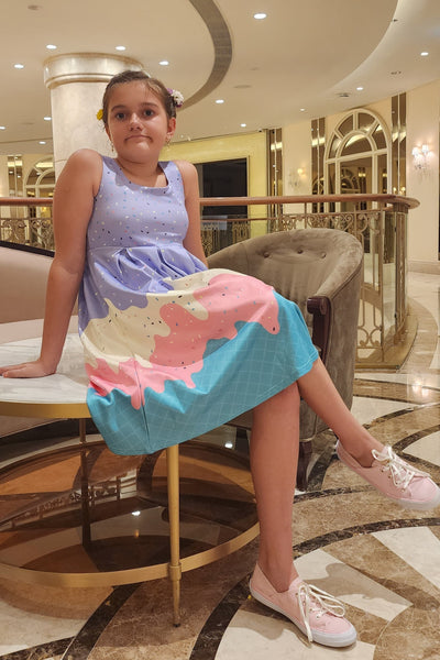 A pretty girl wearing a Kids Melted Ice Cream Swing Dress
