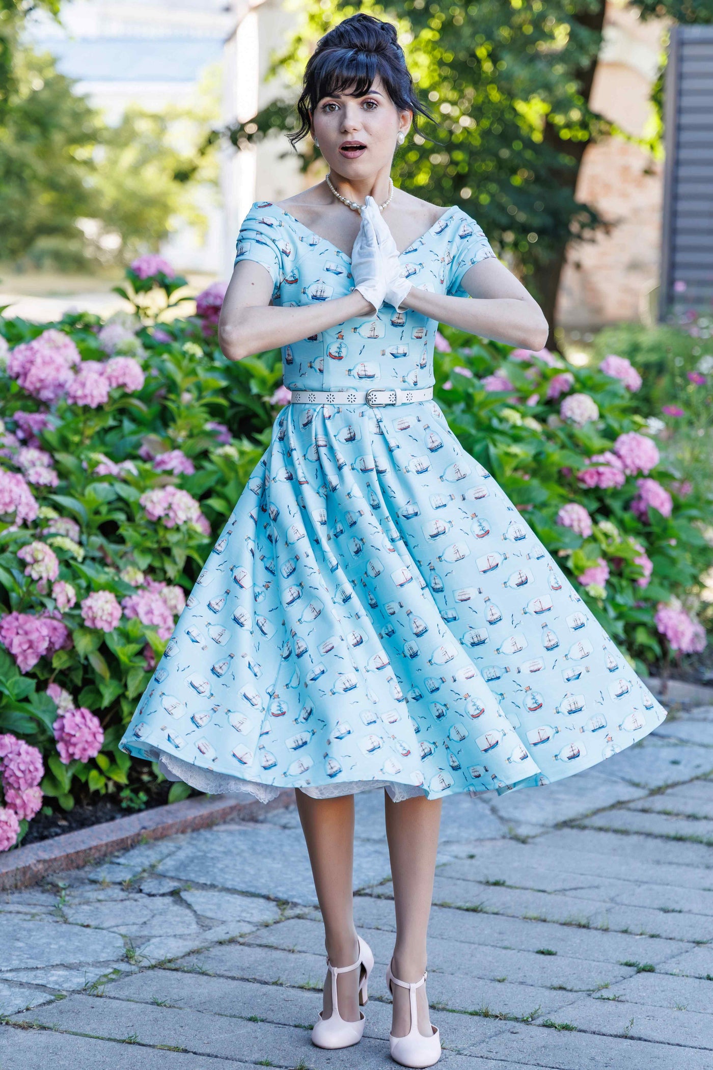  A woman wearing a Message In A Bottle Off Shoulder Dress