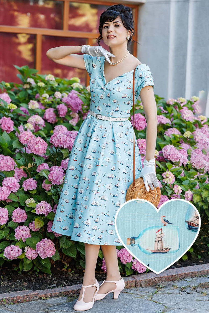  A model wearing a Message In A Bottle Off Shoulder Dress