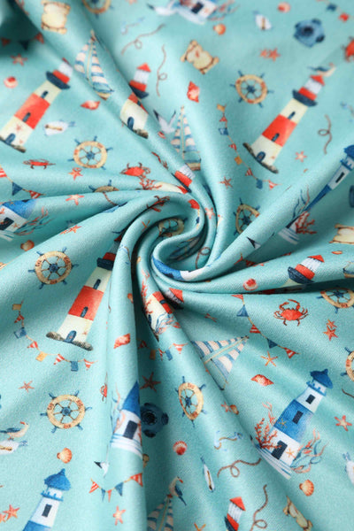 Close up view of Nautical Lighthouse Print Day Dress in Light Blue