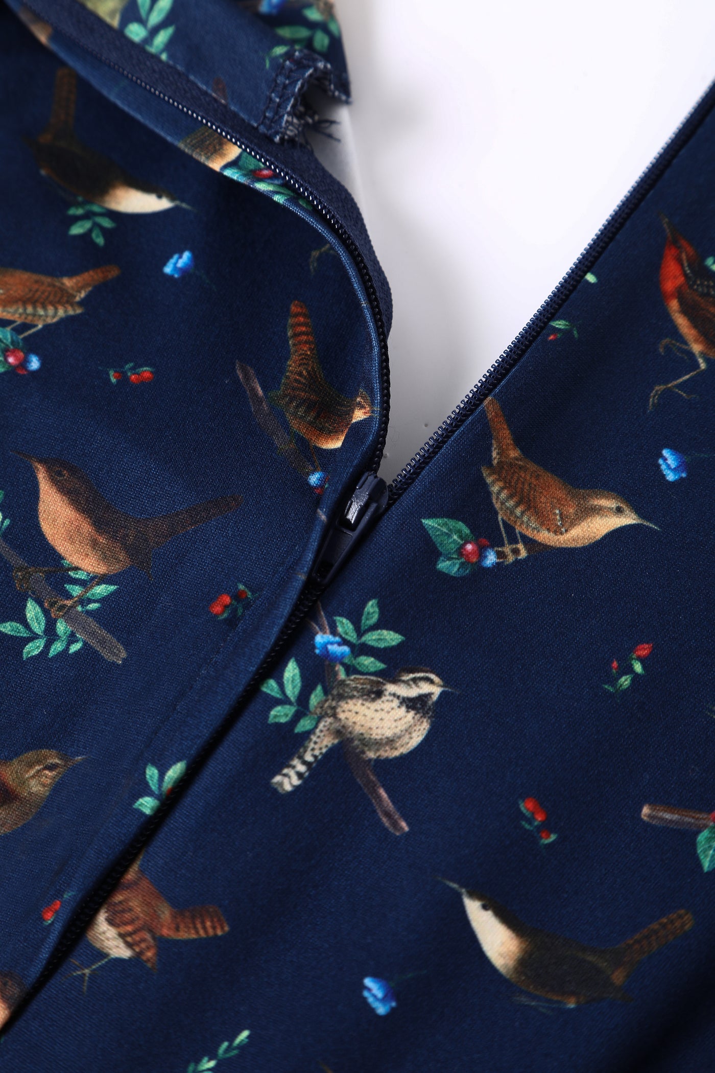 Close up view of navy blue bird print sleeved swing dress