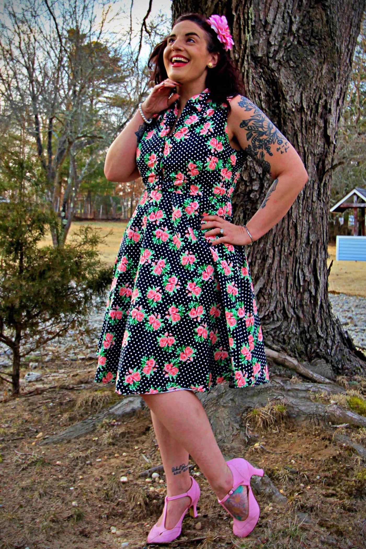 A lady wearing a Navy Blue Polka Dot Rose Shirt Dress