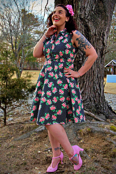 A lady wearing a Navy Blue Polka Dot Rose Shirt Dress