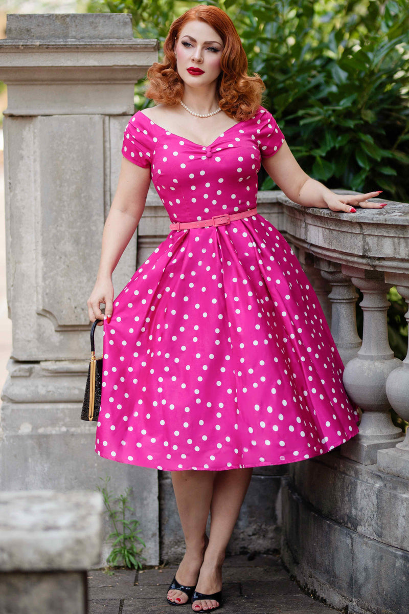 A model wearing a Off-Shoulder Polka Dot Evening Dress in Hot Pink/White