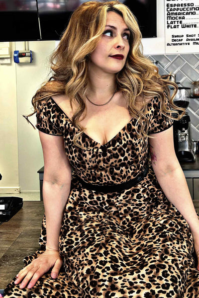 A lady wearing a Off-Shoulder Swing Dress in Brown Leopard Print