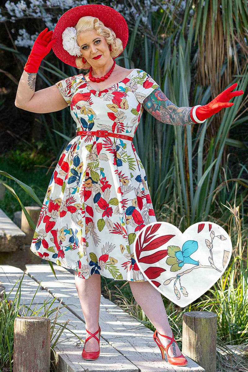 A model wearing a Off Shoulder Tropical Floral Swing Dress In White
