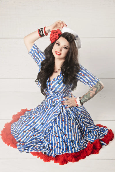 A lady wearing an Old School Tattoo Blue Striped Wrap Dress