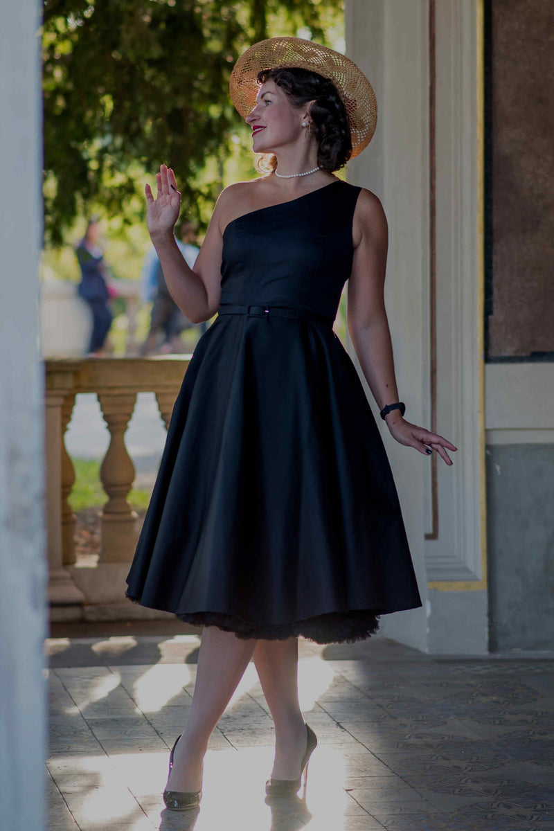 A lady wearing a One Shoulder Black Swing Dress
