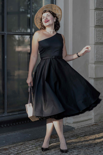 A lady wearing a One Shoulder Black Swing Dress