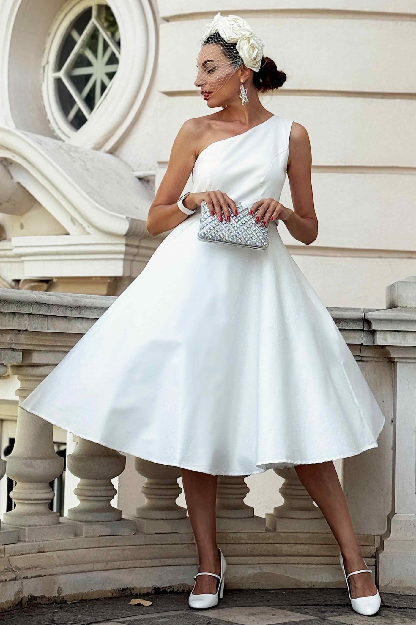 A lovely model wearing a Susan One Shoulder White Swing Dress