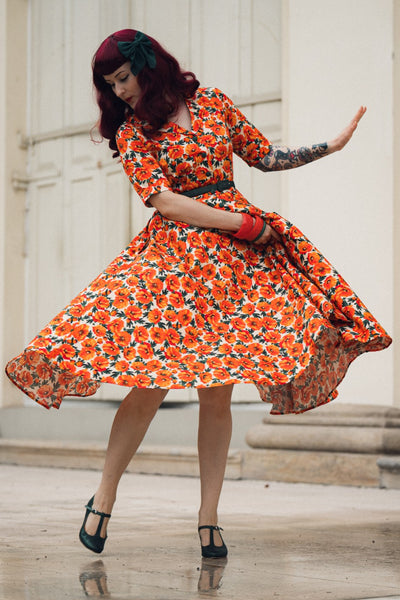 A lady in Mollie Orange Poppy Full Circle Shirt Dress