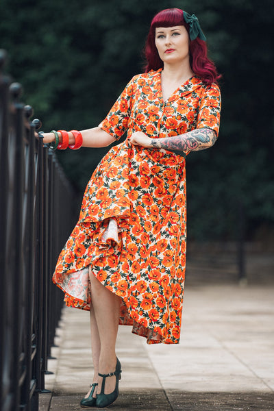 A woman in Mollie Orange Poppy Full Circle Shirt Dress