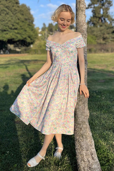 A model wearing a Pastel Dinosaur Off Shoulder Dress