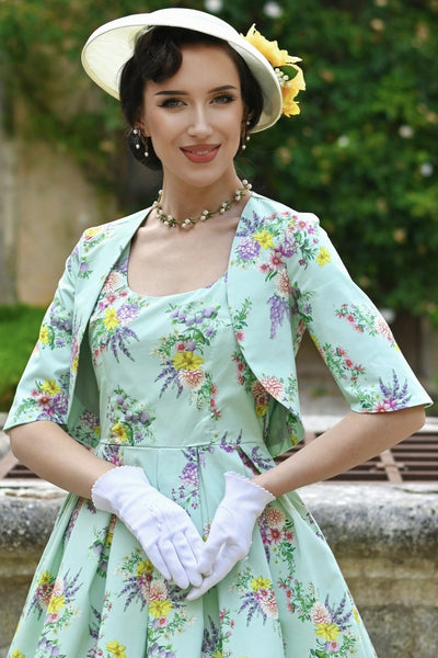 A model earing a Lisette Pastel Floral Bolero Jacket in Light Green