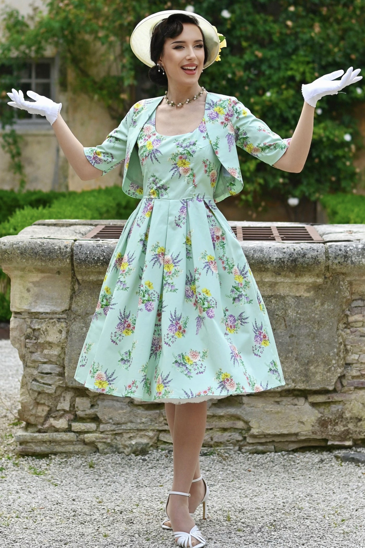 A lady wearing a Lisette Pastel Floral Bolero Jacket in Light Green