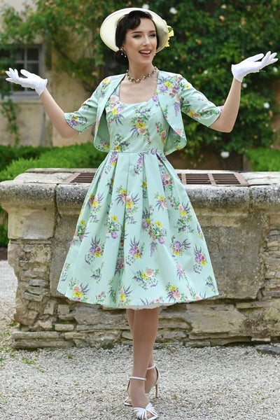 A lady wearing a Lisette Pastel Floral Bolero Jacket in Light Green
