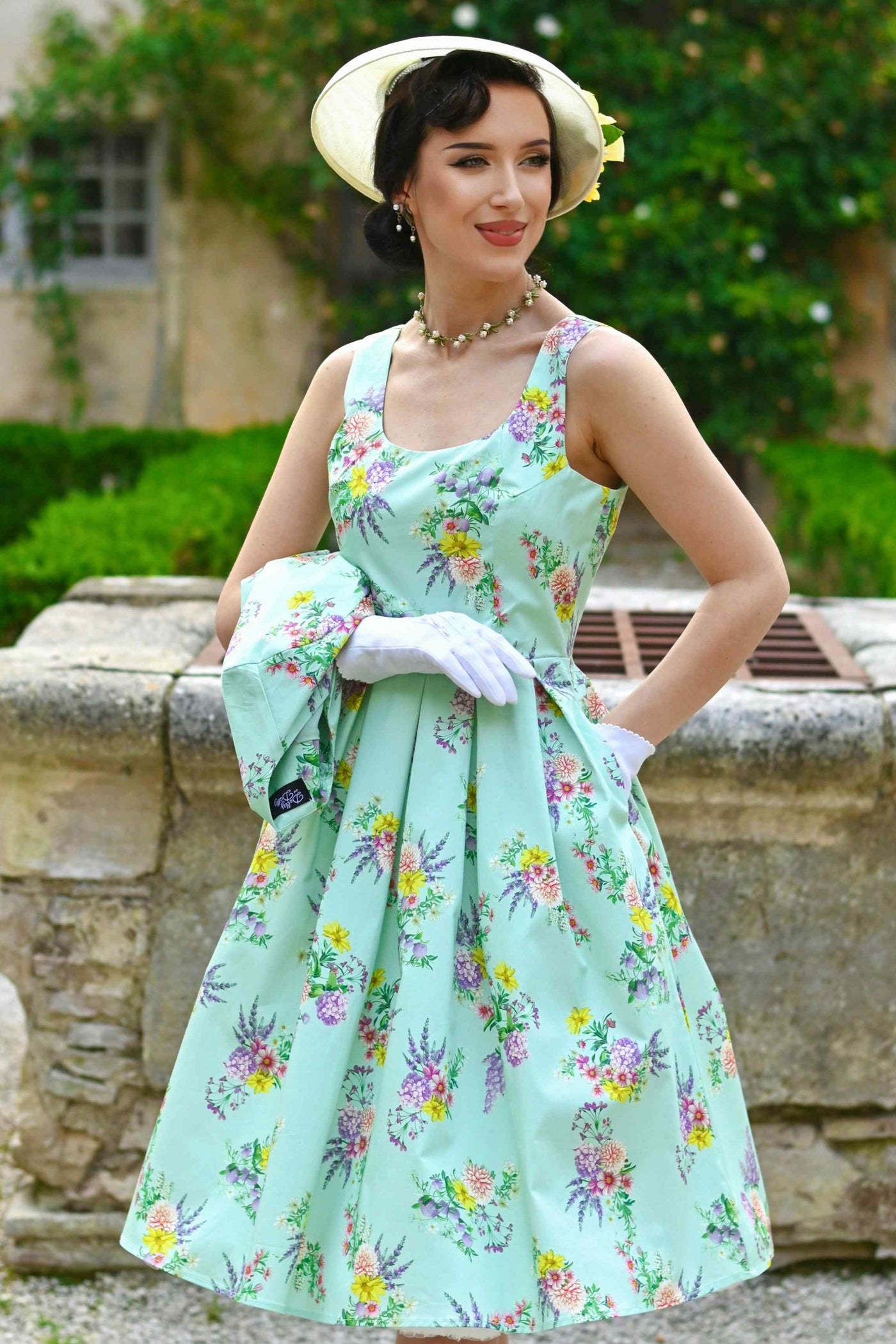Close up view a model wearing Amanda Pastel Floral Swing Dress In Light Green