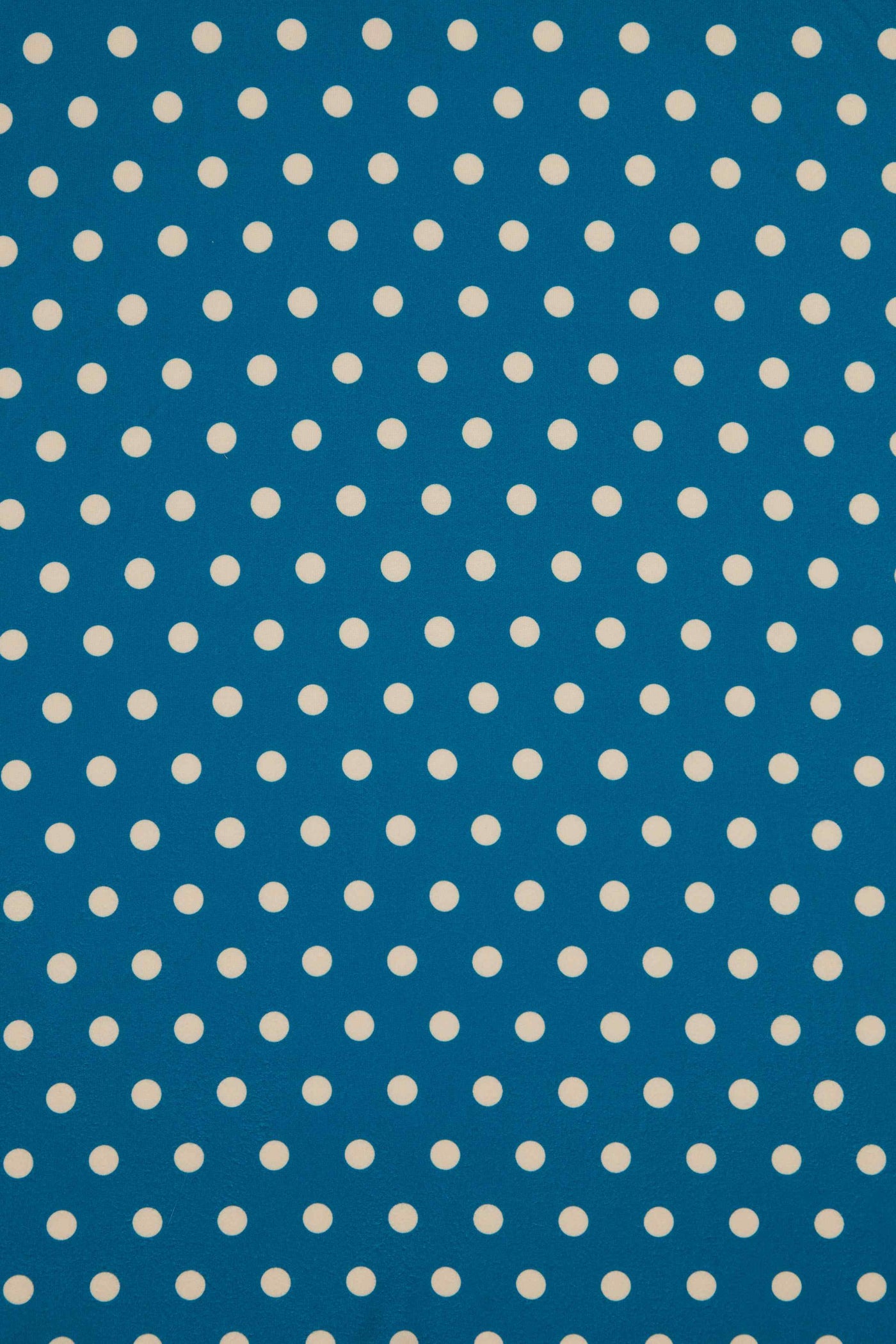 Close Up View of Peacock Blue and Cream Polka Dot Wrap Dress