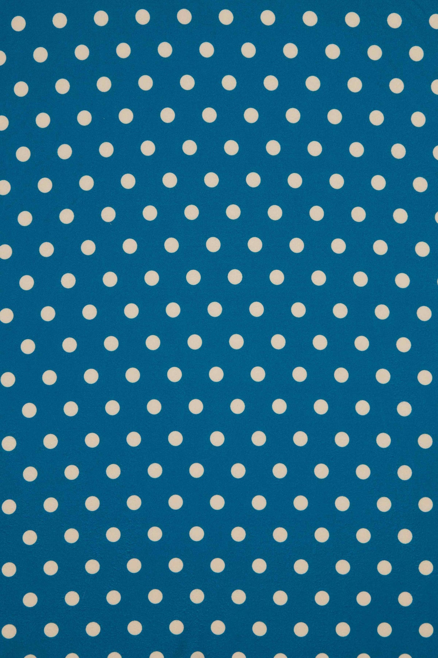 Close Up View of Peacock Blue and Cream Polka Dot Wrap Dress