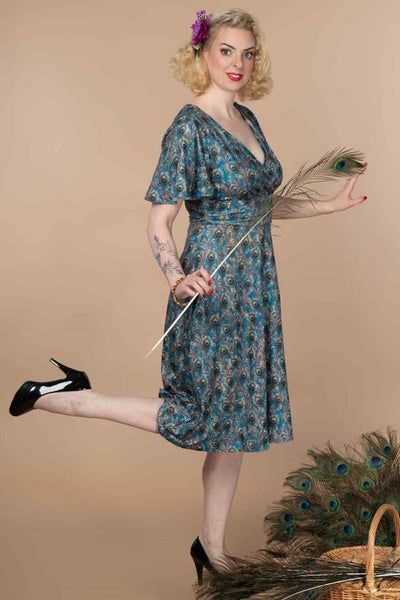 A model wearing Peacock Feather Crossover Bust Dress
