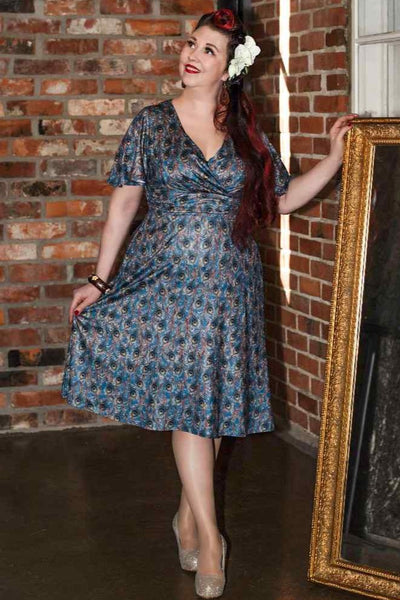 A lady wearing a Peacock Feather Crossover Bust Dress
