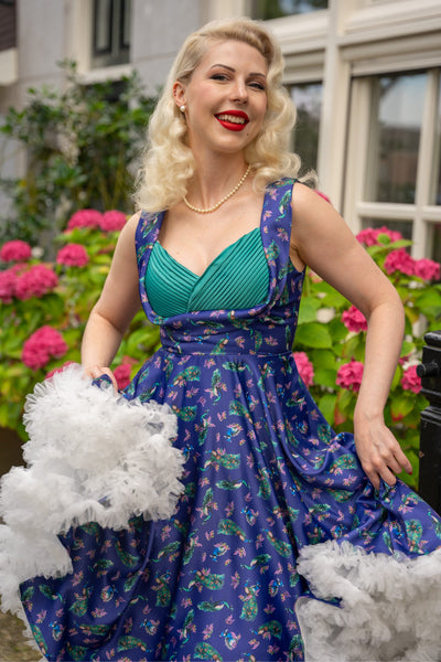 A model wearing a purple Peacock Pleated Bust Dress