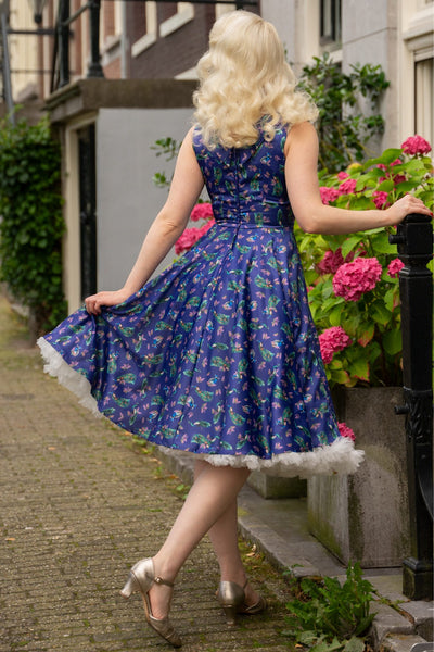 A model wearing a purple Peacock Pleated Bust Dress