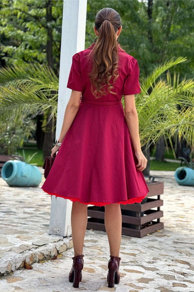 A woman wearing a Penelope Retro Red Shirt Dress