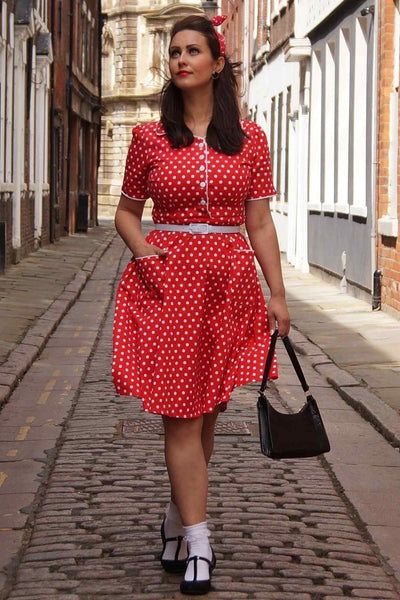 A lady wearing a Pin Up Style Shirt Dress In Classic Red & White Polka Dots