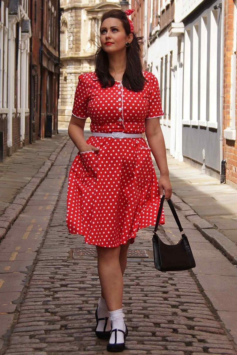 A lady wearing a Pin Up Style Shirt Dress In Classic Red & White Polka Dots
