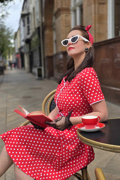 A lady wearing a Pin Up Style Shirt Dress In Classic Red & White Polka Dots