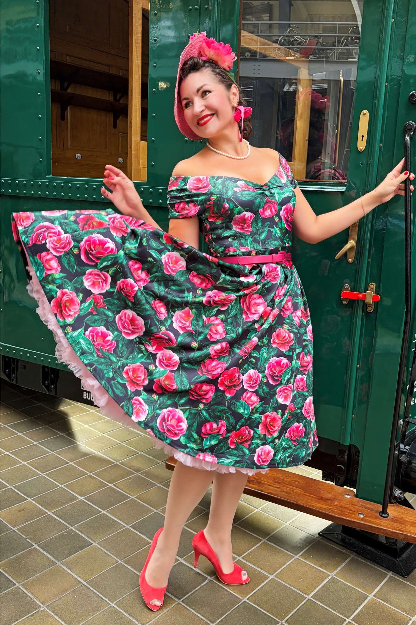 A lovely lady wearing a Lily Pink Camellia Off Shoulder Dress In Black