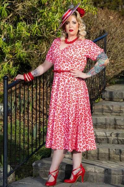 A model wearing a Julia Pink Cheetah Print Midi Dress